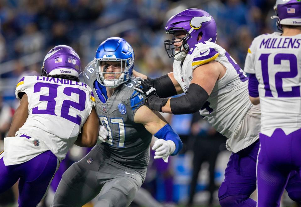 Detroit Lions defensive end Aidan Hutchinson attempts to tackle Minnesota Vikings quarterback Nick Mullens at Ford Field in Detroit on Sunday, Jan. 7, 2024.