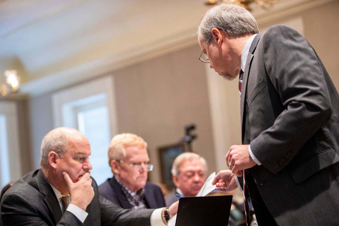 Creighton Waters, a prosecutor for the S.C. Attorney General’s office hands off a photograph to defense attorney Jim Griffin, Alex Murdaugh and Dick Harpootlian in the double murder trial of Alex Murdaugh at the Colleton County Courthouse in Walterboro, S.C., Monday, Jan. 30, 2023. (Andrew J. Whitaker/The Post And Courier via AP, Pool)