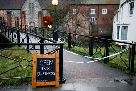 Police officers stand on duty outside a pub which has been secured as part of the investigation into the poisoning of former Russian intelligence agent Sergei Skripal and his daughter Yulia, in Salisbury, Britain March 12, 2018. REUTERS/ Henry Nicholls