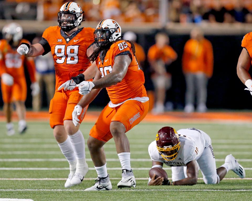 Sep 1, 2022; Stillwater, Oklahoma, USA; Oklahoma State Cowboys defensive end Justin Hines (85) celebrates his sack of Central Michigan Chippewas quarterback Daniel Richardson (10) with  Brendon Evers (98) in the third quarter at Boone Pickens Stadium. OSU won 58-44. Mandatory Credit: Sarah Phipps-USA TODAY Sports