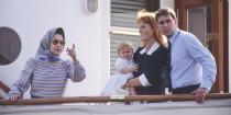 <p>Queen Elizabeth, Sarah, Duchess of York, and Prince Andrew stand together on the Royal Yacht Britannia.</p>