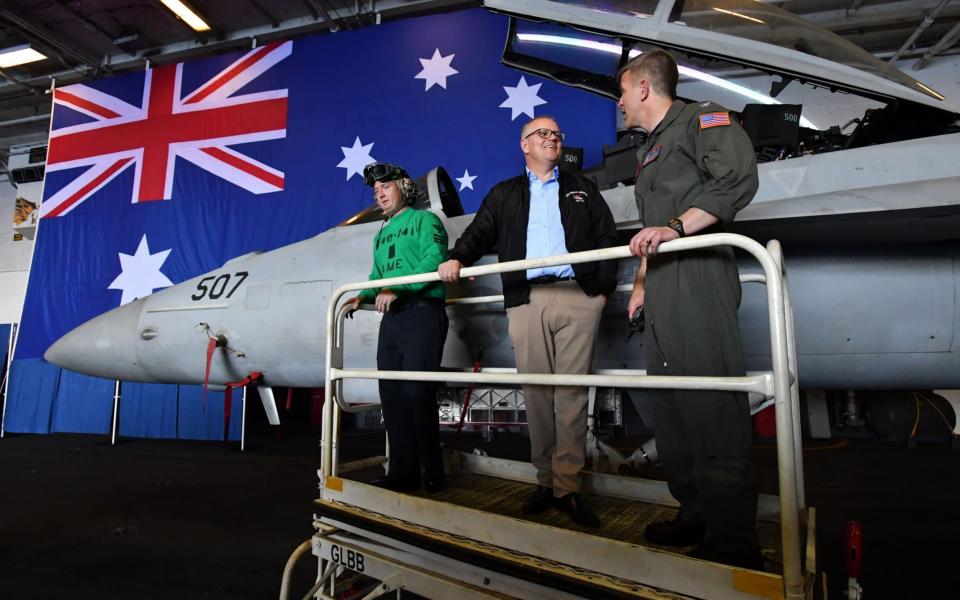 Australian Prime Minister Scott Morrison stands with the Commanding officer of the USS Ronald Reagan - REX