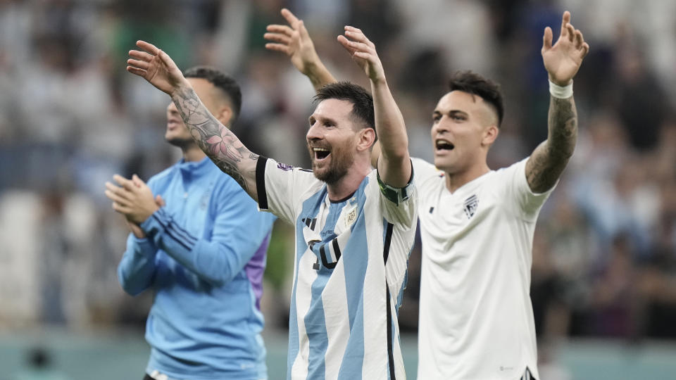 Argentina's Lionel Messi, center, celebrates after winning the World Cup group C soccer match between Argentina and Mexico at the Lusail Stadium in Lusail, Qatar, Sunday, Nov. 27, 2022. (AP Photo/Moises Castillo)