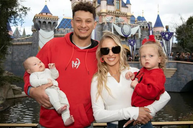 <p>Christian Thompson/Disneyland Resort via Getty</p> Patrick Mahomes of the Kansas City Chiefs and Brittney Mahomes pose with their children.