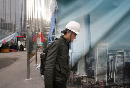 A worker walks outside the construction sites in Beijing's central business area, China January 18, 2019. Picture taken January 18, 2019. REUTERS/Jason Lee