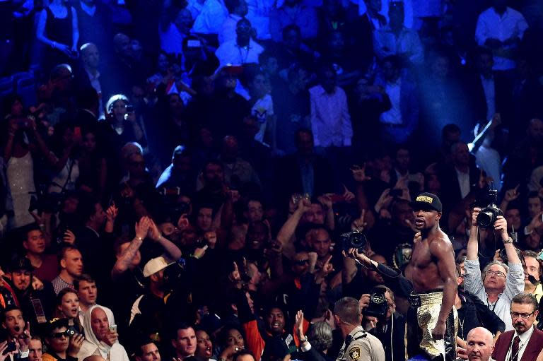 The crowd take smartphone photos of Floyd Mayweather as he celebrates his unanimous decision victory against Manny Pacquiao on May 2, 2015 at the MGM Grand Garden Arena