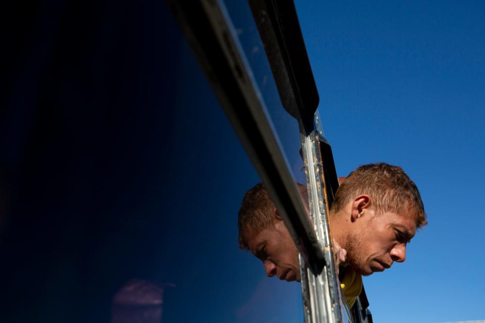 A migrant from Venezuela looks out the window after arriving at the federal shelter Leonora Vicario in Ciudad Juárez. The migrants were escorted by Chihuahua State Police and the Mexican National Guard. Many of these migrants had been kidnapped by organized crime in the State of Durango and were being escorted to the border city for their protection on Dec. 11, 2022.