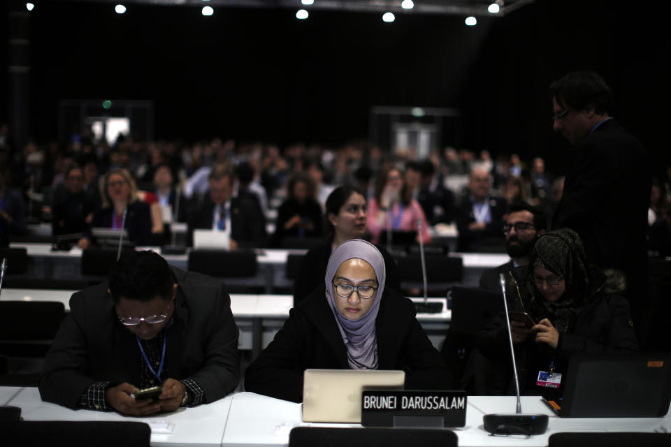 Participants take part at the COP25 climate talks congress in Madrid, Spain, Saturday, Dec. 14, 2019. The United Nations Secretary-General has warned that failure to tackle global warming could result in economic disaster. (AP Photo/Manu Fernandez)