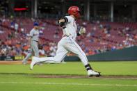 Cincinnati Reds' Tyler Naquin runs to first base after hitting a single against the New York Mets during the fourth inning of a baseball game in Cincinnati, Tuesday, July 5, 2022. (AP Photo/Aaron Doster)