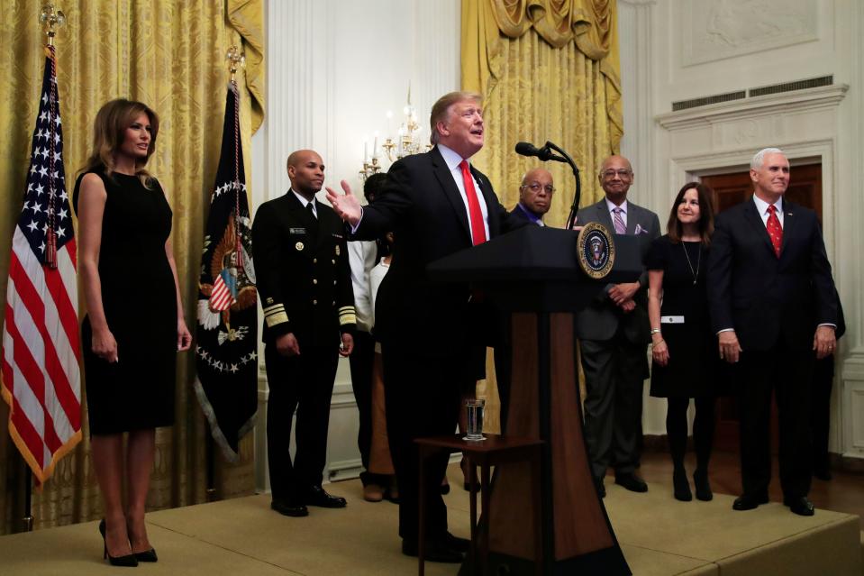 President Donald Trump with first lady Melania Trump, left, Vice President Mike Pence, right, and his wife Karen Pence, speaks during a National African American History Month reception in the East Room of the White House in Washington, Thursday, Feb. 21, 2019.