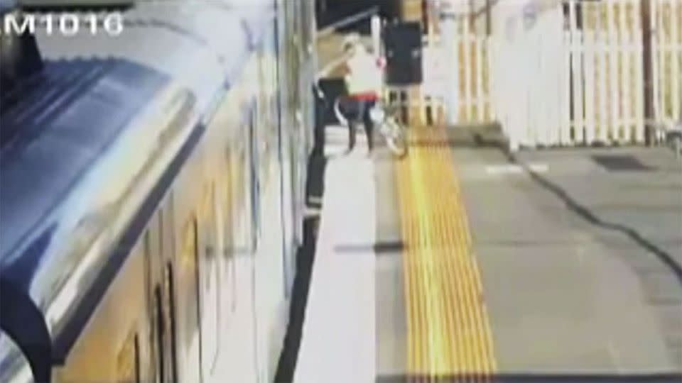 Zari was the last member of his family to board the train and can be seen attempting to push his bike on to the carriage. Photo: 7 News