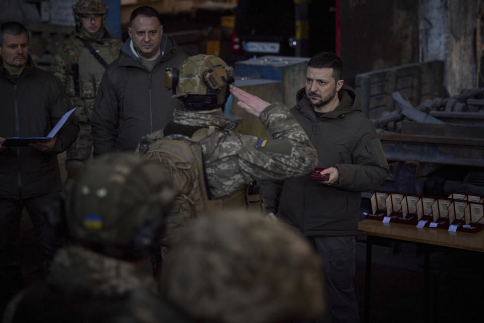 In this photo provided by the Ukrainian Presidential Press Office, Ukrainian President Volodymyr Zelenskyy, right, awards a serviceman at the site of the heaviest battles with the Russian invaders in Bakhmut, Ukraine, Tuesday, Dec. 20, 2022. (Ukrainian Presidential Press Office via AP)