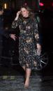 <p>In a Orla Kiely-designed black long-sleeved floral print dress with velvet detailing, paired with nude suede pumps, a small clutch, and gold teardrop earrings at the National Portrait Gallery in London.</p>