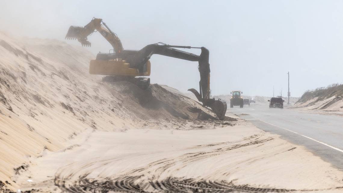 NC DOT crews clear sand along highway NC 12 on Pea Island Thursday, Sept. 14, 2023 as Hurricane Lee churns on a Northward track hundreds of miles offshore in the Atlantic. 