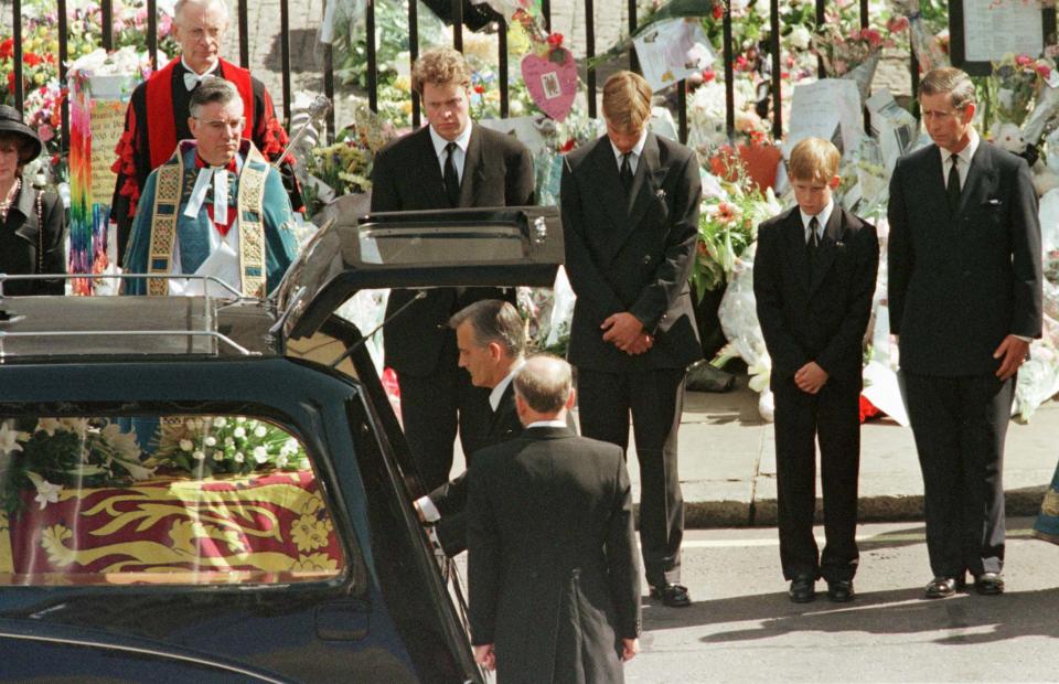 Earl Spencer, Prince William, Prince Harry and Prince Charles watch as the coffin of Diana, Princess of Wales is placed into a hearse at Westminster Abbey following her funeral service, September 6, 1997. Millions of mourners lined the route to pay their respects. Reuters Photographer / Reuters