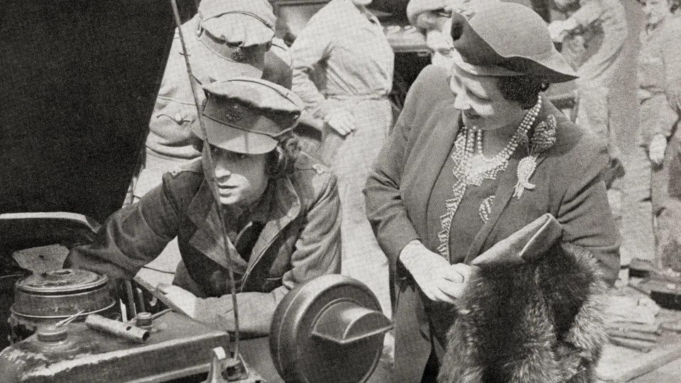 <p>Princess Elizabeth, left, learns basic car maintenance as a Second Subaltern in the Auxiliary Territorial Service on 12 April 1945, watched by her mother, the Queen, during the Second World War. (Getty Images)</p> 
