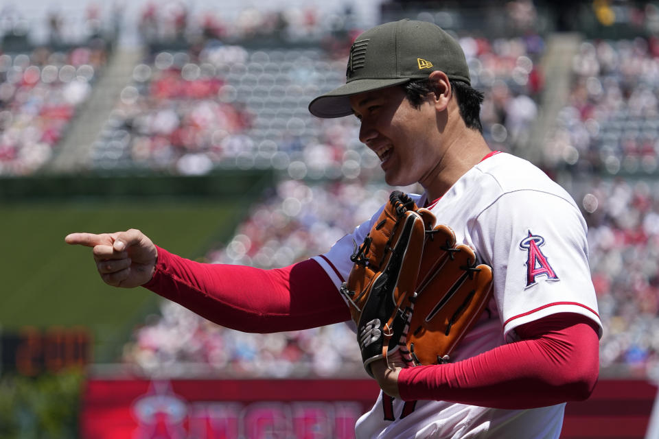 Los Angeles Angels starting pitcher Shohei Ohtani gestures toward teammates as he walks back to the dugout after the top of the second inning of a baseball game against the Minnesota Twins Sunday, May 21, 2023, in Anaheim, Calif. (AP Photo/Mark J. Terrill)