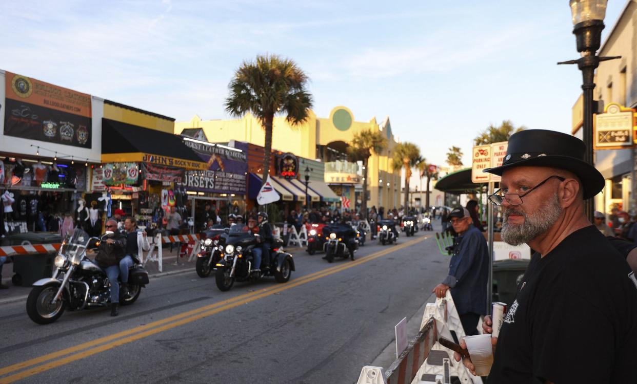 People watch the bikers ride down Main Street in Daytona, FL during Bike Week on March 5, 2021. (Sam Thomas/Orlando Sentinel)