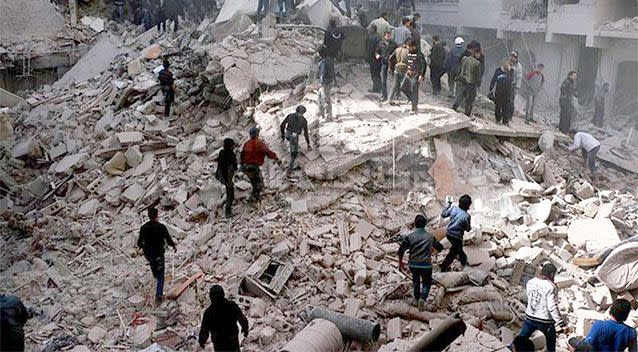 Syrians inspect the rubble of a destroyed building in Aleppo following a government airstrike. Photo: AP