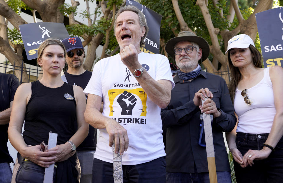 Rhea Seehorn, from left, Matt Jones, Bryan Cranston, writer Peter Gould and Betsy Brandt, from the acting and writing team of "Breaking Bad," speak on a picket line outside Sony Pictures studios on Tuesday, Aug. 29, 2023, in Culver City, Calif. The film and television industries remain paralyzed by Hollywood's dual actors and screenwriters strikes. (AP Photo/Chris Pizzello)