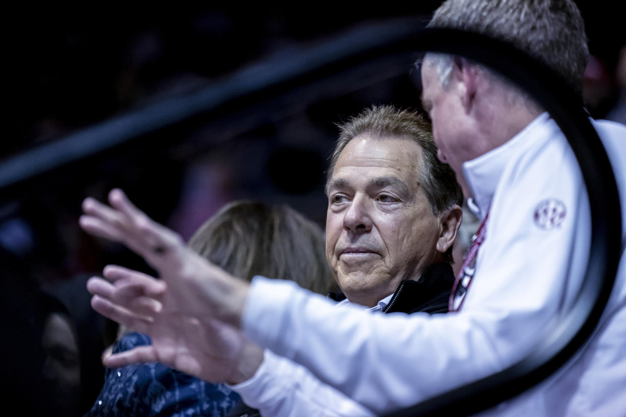 Alabama football coach Nick Saban talks with athletic director Greg Byrne, right, while watching Alabama play against Georgia during the first half of an NCAA college basketball game Saturday, Feb. 18, 2023, in Tuscaloosa, Ala. (AP Photo/Vasha Hunt)