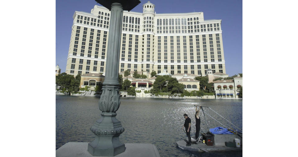 FILE - A crew cleans and tests the fountains at the Bellagio Casino and Hotel resort in Las Vegas, Nevada, on April 14, 2004. The Bellagio said in a social media post Tuesday, March 5, 2024 that it paused its fountains as it worked with state wildlife officials to rescue a yellow-billed loon who "found comfort on Las Vegas' own Lake Bellagio." (Matthew Minard/Las Vegas Sun via AP, file)