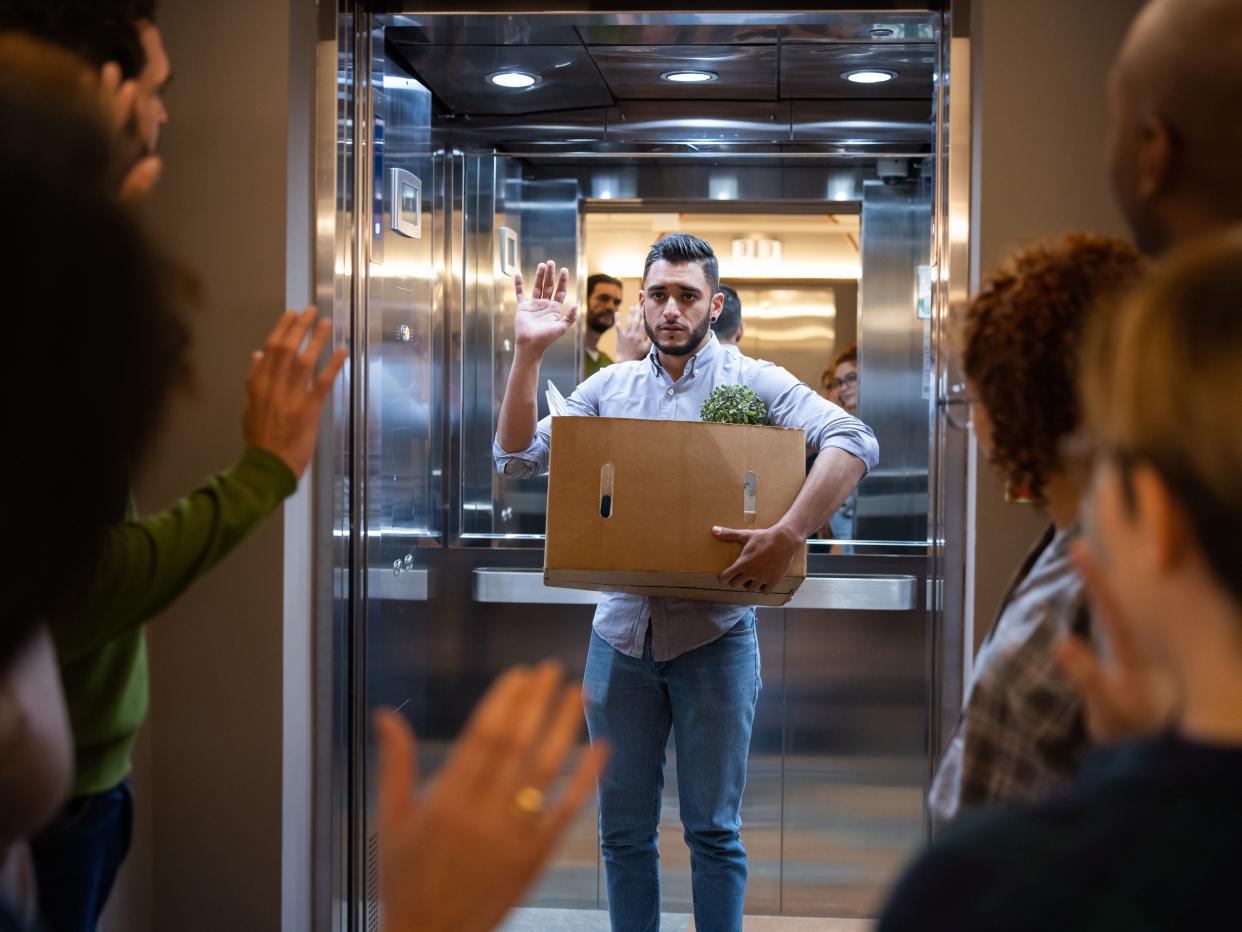 man getting laid off and waving goodbye