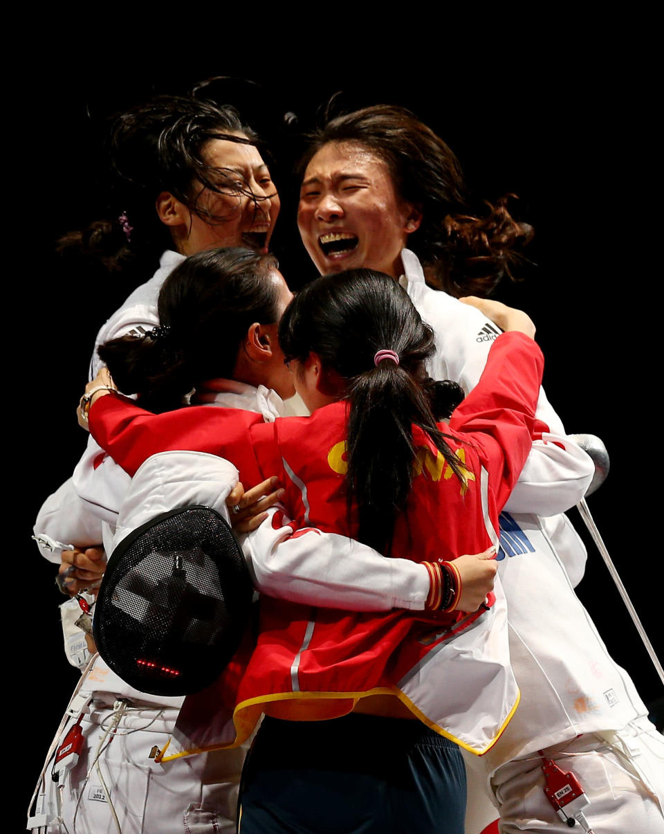 LONDON, ENGLAND - AUGUST 04: Na Li, Xiaojuan Luo, Yujie Sun and Anqi Xu of China celebrate their 39-25 win over Korea during their Gold Medal Match in the Women's Epee Team Fencing Finals on Day 8 of the London 2012 Olympic Games at ExCeL on August 4, 2012 in London, England. (Photo by Hannah Johnston/Getty Images)