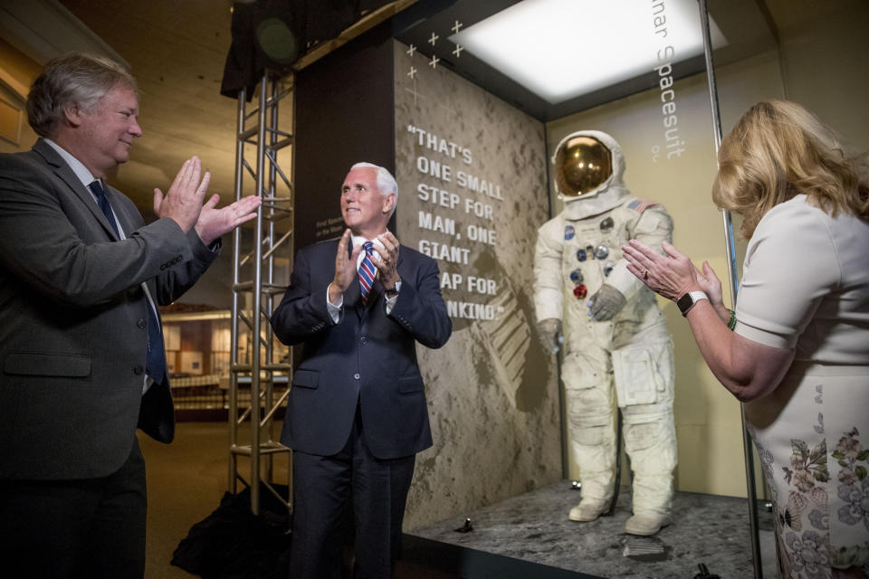 From left, Rick Armstrong, the son of Neil Armstrong, Vice President Mike Pence, and Smithsonian's National Air and Space Museum Director Ellen Stofan, unveil Neil Armstrong's Apollo 11 spacesuit at the Smithsonian's National Air and Space Museum on the National Mall in Washington, Tuesday, July 16, 2019. (AP Photo/Andrew Harnik, Pool)