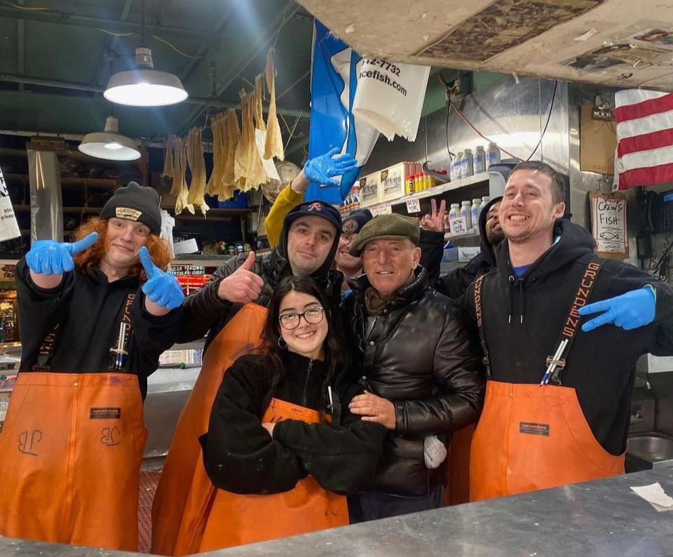 Bruce Springsteen and crew at the Pike Place Fish Market in Seattle on Feb. 26.