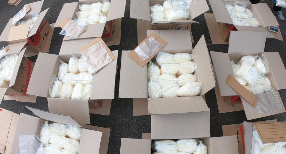 Photo shows numerous moving boxes filled to the brim with zip-locked bags of methylamphetamine.