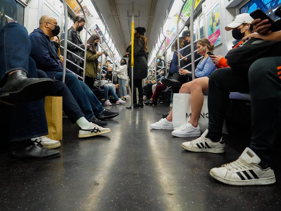 People sitting in a subway car.