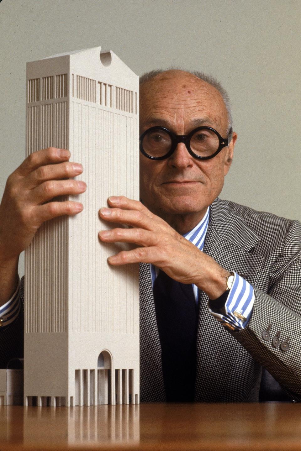 Philip Johnson's iconic “Chippendale” topped AT&T headquarters, now known as 550 Madison, heralded the ascendance of postmodern architecture with cheeky historical pastiche. Pictured here is the Pritzker Prize–winning architect with a model of the New York skyscraper in May 1978.