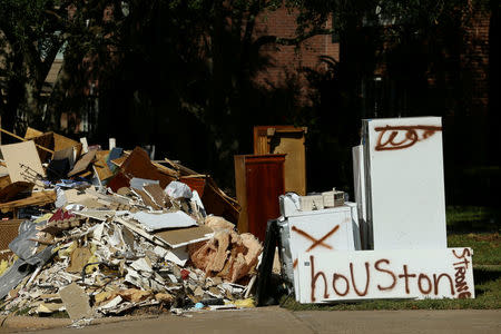 FILE PHOTO: Flood-damaged contents from homes line the roads along residential streets in the aftermath of tropical storm Harvey on the west side of Houston, Texas, U.S., September 7, 2017. REUTERS/Mike Blake/File Photo