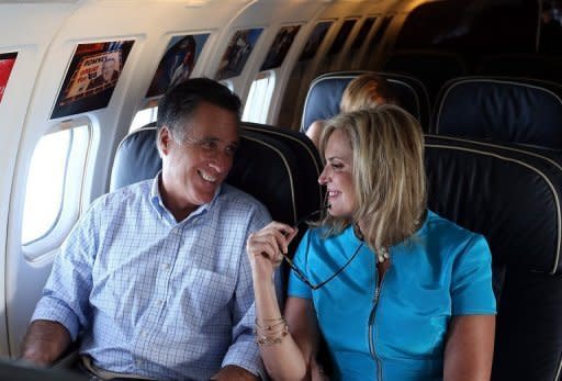 Republican presidential candidate Mitt Romney (L) and his wife Ann Romney talk on the campaign plane on September 1. Romney has criticized setting a withdrawal date for US forces from Afghanistan, saying doing so would aid US enemies. But he has also suggested that the "right timetable" for a withdrawal is by the end of 2014 -- a date already set by NATO