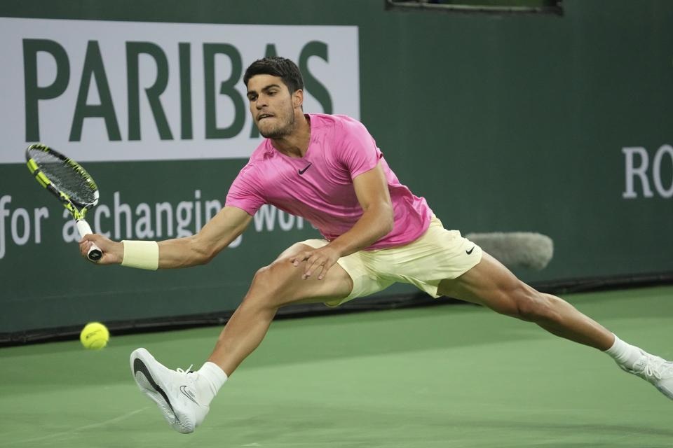 Carlos Alcaraz, of Spain, returns a shot to Felix Auger-Aliassime, of Canada, at the BNP Paribas Open tennis tournament Thursday, March 16, 2023, in Indian Wells, Calif. (AP Photo/Mark J. Terrill)