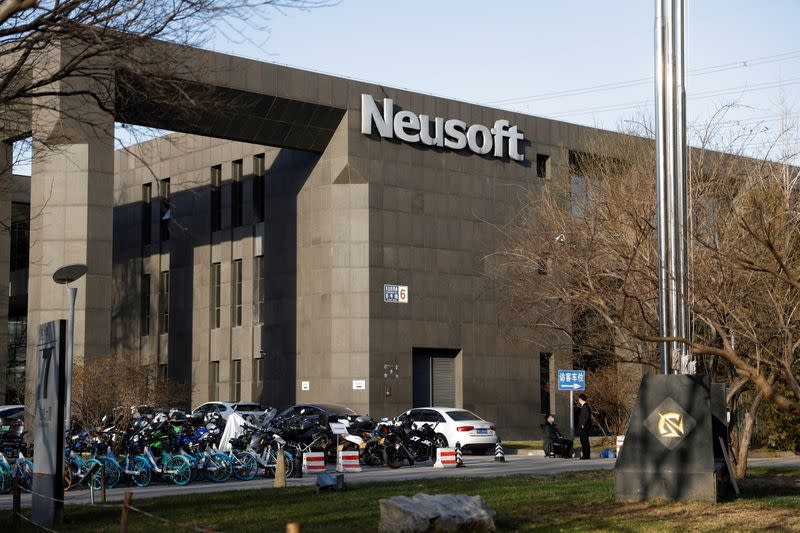 Men speak outside one of Neusoft's office buildings in Beijing