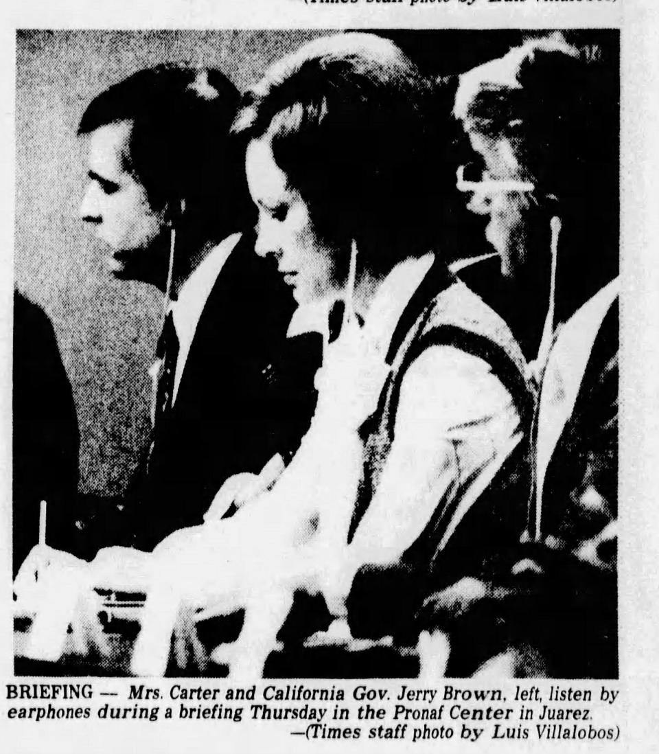 Mrs. Carter and California Gov. Jerry Brown, left, listen by earphones during a briefing November 3, 1977, in the Pronaf Center in Juárez.