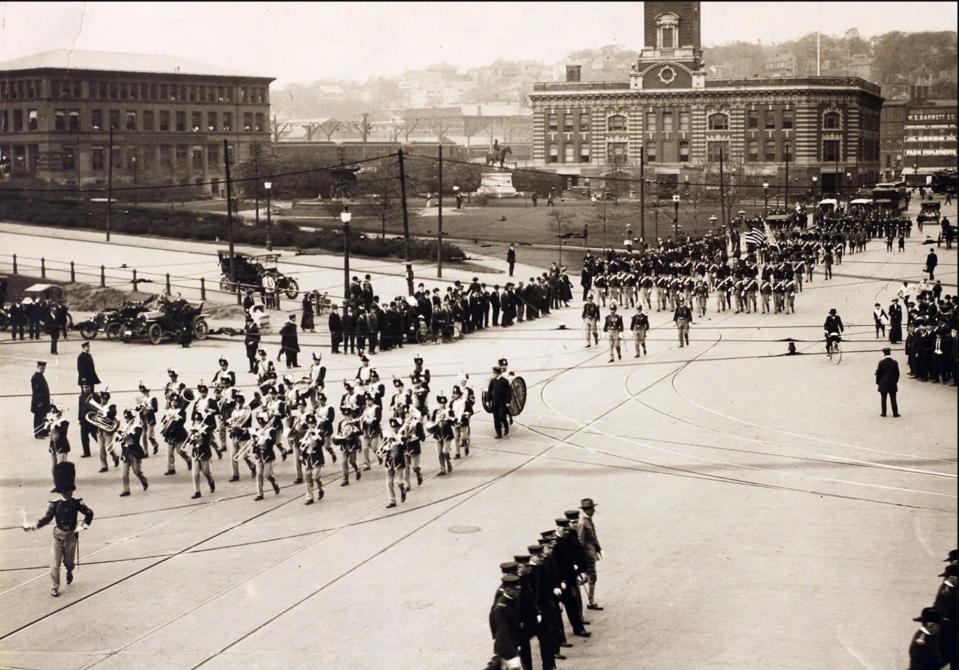 The First Light Infantry marches through Exchange Place in Providence in an early 1920s Independence Day parade. The old railroad station is on the left.