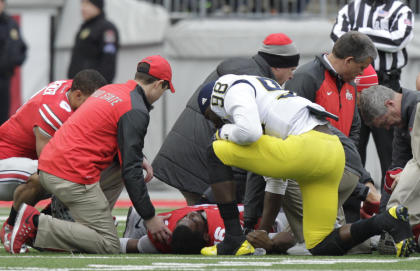 J.T. Barrett is attended to after breaking his leg last year against Michigan. (AP)