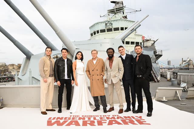 <p>Dave Hogan/Hogan Media/Shutterstock</p> (Left-right:) Henry Cavill, Henry Golding, Eiza González, Cary Elwes, Babs Olusanmokun, Hero Feinnes Tiffin and Alex Pettyfer aboard HMS Belfast on March 22 in London