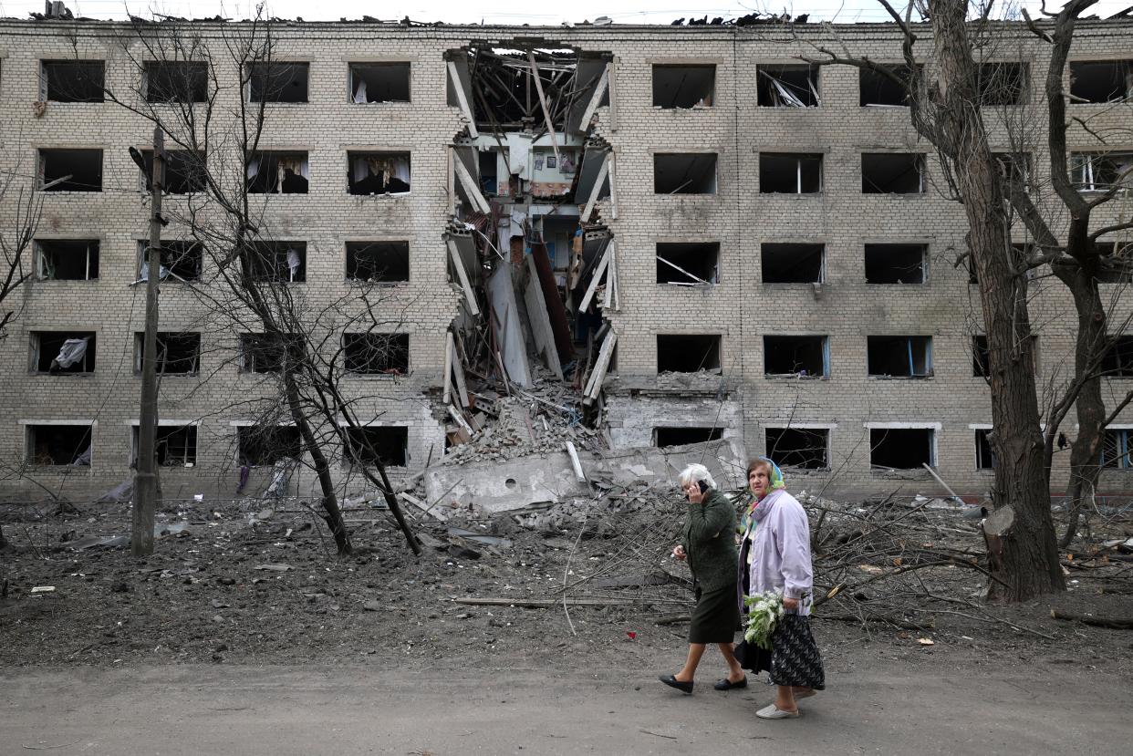 File photo: Elderly women walk past a hostel destroyed during a missile attack in the town of Selydove, Donetsk region (AFP via Getty Images)