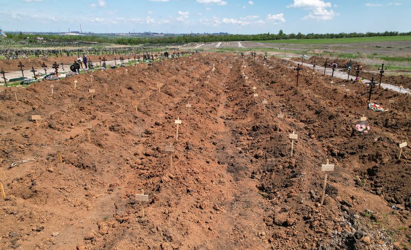 A view shows newly-made graves at a cemetery outside Mariupol