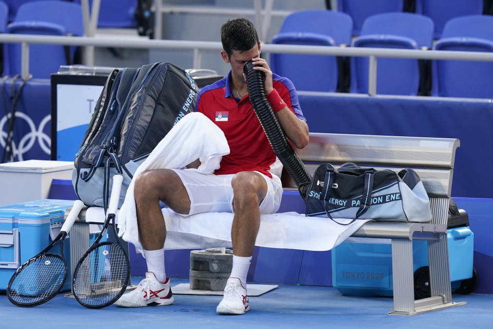 Novak Djokovic, of Serbia, cools off during a third round men's tennis match against Alejandro Davidovich Fokina, of Spain, at the 2020 Summer Olympics, Wednesday, July 28, 2021, in Tokyo, Japan. (AP Photo/Patrick Semansky)