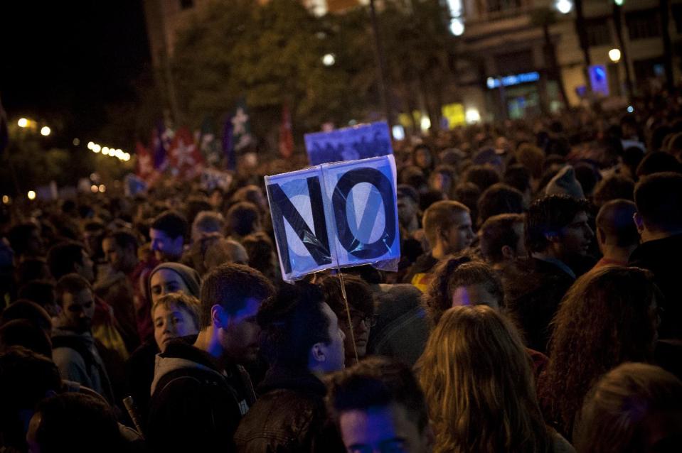 Protestors gather near Parliament demonstrating against austerity measures announced by the Spanish government in Madrid, Spain, Saturday, Sept. 29, 2012. Tens of thousands of Spaniards and Portuguese rallied in the streets to protest enduring deep economic pain from austerity cuts. In Madrid, demonstrators approached parliament for the third time this week to vent their anger against tax hikes, government spending cuts and the highest unemployment rate among the 17 nations that use the euro. (AP Photo/Daniel Ochoa De Olza)