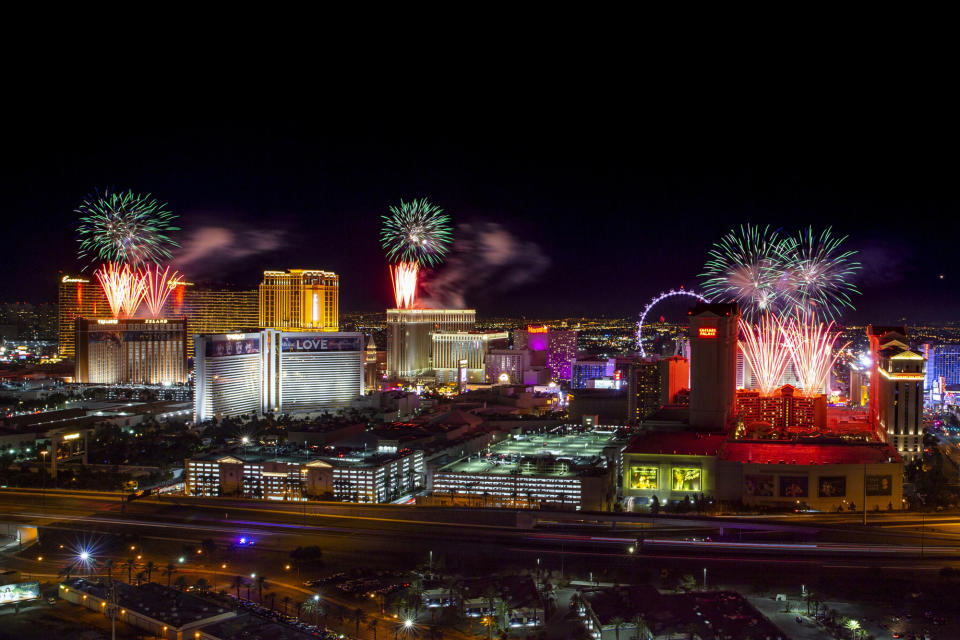 FILE- IN this Jan. 1, 2020 file photo, fireworks for New Year's Eve erupt over the Strip as viewed from the VooDoo Rooftop Nightclub & Lounge at Rio All-Suite Hotel & Casino on in Las Vegas. If ever a year's end seemed like cause for celebration, 2020 might be it. Yet the coronavirus scourge that dominated the year is also looming over New Year's festivities and forcing officials worldwide to tone them down. (L.E. Baskow/Las Vegas Review-Journal via AP, File)