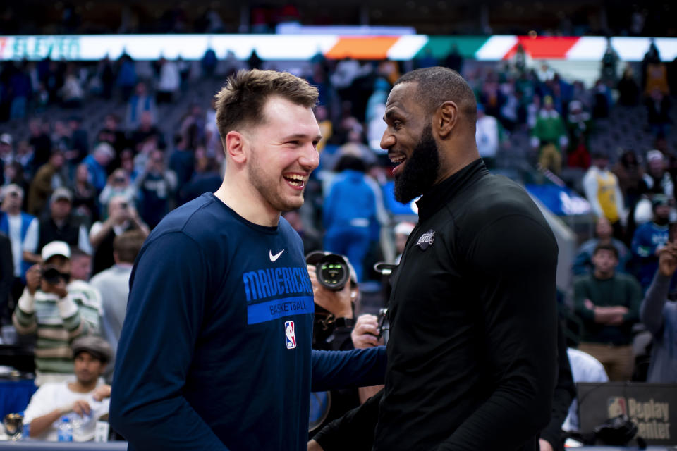 Dallas Mavericks guard Luka Doncic shares a laugh with Los Angeles Lakers forward LeBron James following an NBA basketball game in Dallas, Sunday, Dec. 25, 2022. Dallas won the game by a final of 124-115. (AP Photo/Emil T. Lippe)