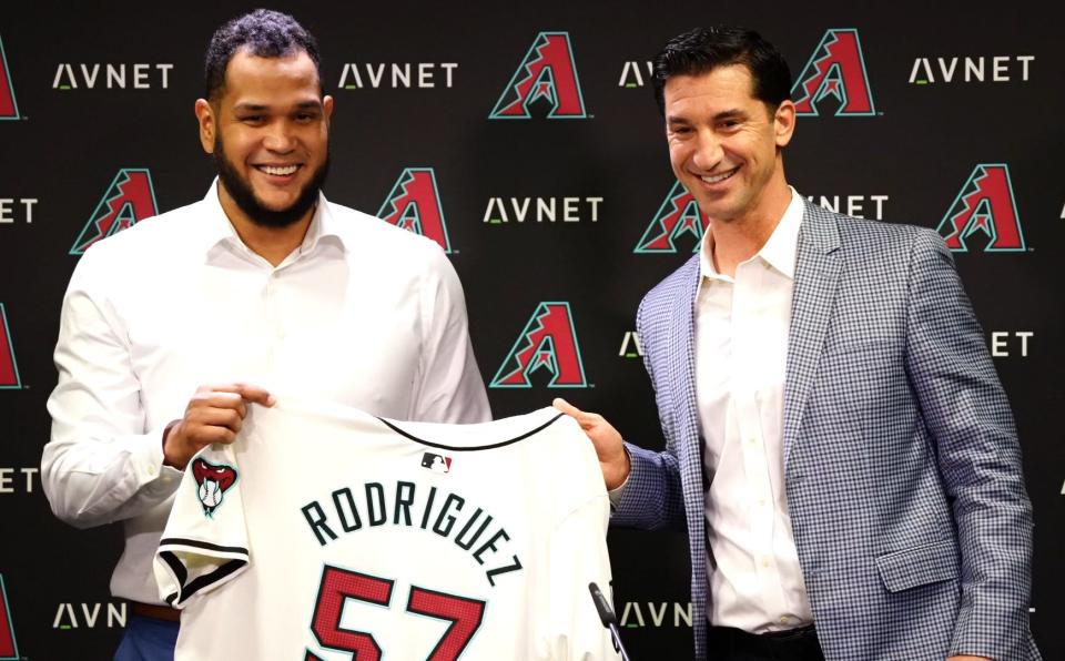 Arizona Diamondbacks starting pitcher Eduardo Rodriguez holds up his jersey with GM Mike Hazen (right) during an introductory news conference at Chase Field on Dec. 12, 2023.