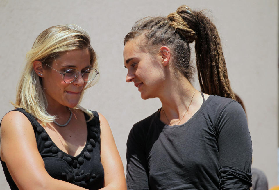 Sea-Watch3 German captain Carola Rackete, right, talks to Sea-Wacht spokesperson Giorgia Linardi as she leaves after being questioned in court in the southern Sicilian town of Agrigento, Italy, Thursday, July 18, 2019. Rackete, who forced a government block docking at an Italian port after rescuing migrants, faces questioning by Italian prosecutors over allegedly aiding illegal immigration. (Pasquale Claudio Montana Lampo/ANSA via AP)