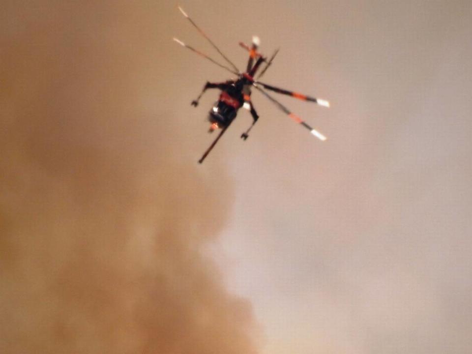 Firefighters were using helicopters, as well as fixed wing planes to fight the fire on the ridge close to Cascadel Woods. Carol Eggink